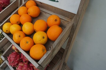 A fresh pile of ripe oranges inside a wooden box, radiating natural sweetness and citrus freshness. Perfect for healthy living, organic markets, and tropical fruit lovers!
