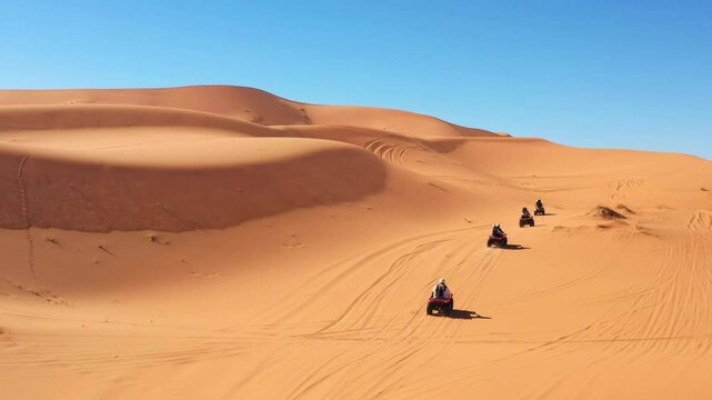 Drone of group driving quad bike on the desert