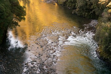 Water Flowing Over Rocks in Riverbed – Serene Nature Scene with Rippling Stream