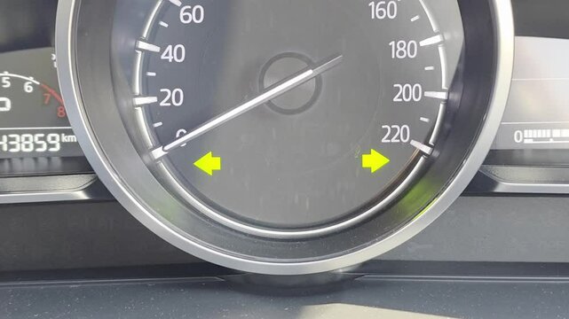 Car speedometer with blinking hazard lights signal indicators