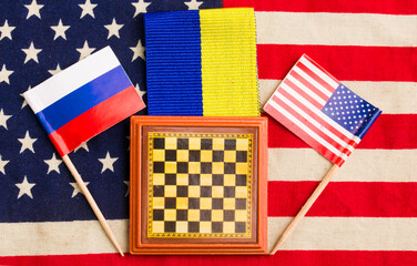 chessboard with flag of ukraine usa and russia.concepts of peace negotiations