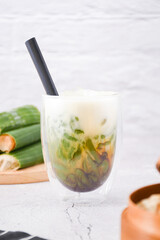 glass of cendol ice, Cendol is an iced sweet dessert that contains droplets of green rice flour jelly, coconut milk and palm sugar syrup. It is commonly found in Indonesia