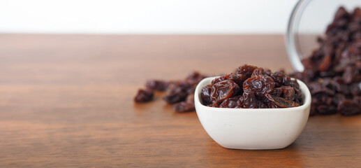 Raisins on wooden table background. Dry raisins.