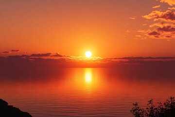 Fototapeta premium Sunset over the sea, an orange sky, a calm water surface.