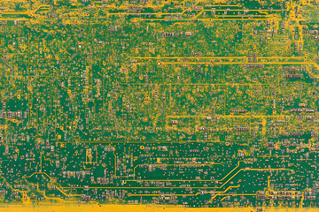 Abstract close-up of a vibrant green and gold circuit board, showcasing intricate technological detail. Ideal for backgrounds, tech themes, and electronic designs.