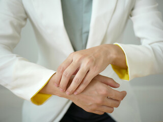 Young Asian woman feels numbness and severe pain in her wrist Caused by sitting and working for a...