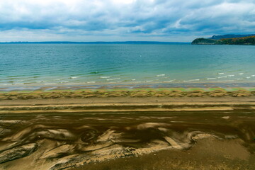 Sandy wild beach of the Volga river on an autumn day