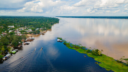 Obraz premium Aerial View of the Amazon River in Colombia with Lush Rainforest and Local Community