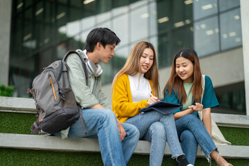Students at university with fun for learning,Walking,laughing and bonding and talking.asian group of gen z friends student giving high five outdoor with books ready for education at college campus.
