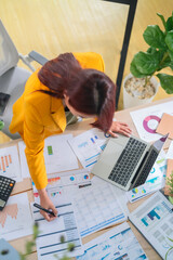 Asian business woman Successful businesswoman analyzing financial reports at work  brainstorm on...
