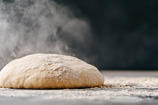 Steaming bread dough resting on a wooden surface with warm baking ambiance