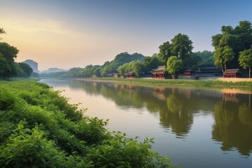 Obraz premium trees and bushes line the bank of a river with a building in the distance