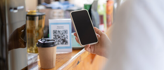 Woman use smartphone to scan QR code for order menu in cafe restaurant with a digital delivery. Choose menu and order accumulate discount. E wallet, technology, pay online, credit card, bank app.