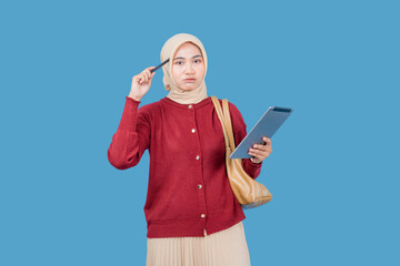 A woman in a red sweater is holding a pen and looking at a tablet. She is deep in thought, possibly contemplating her next move or decision. Concept of focus and concentration