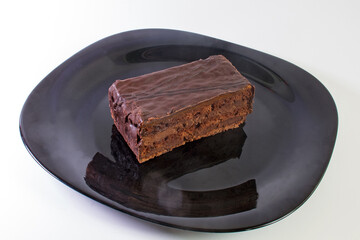 piece of chocolate cake on black plate