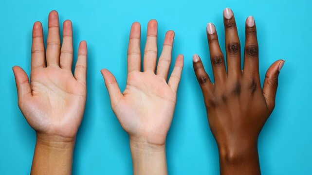 Different skin tones of hands displayed against a bright blue background highlighting diversity and unity among people