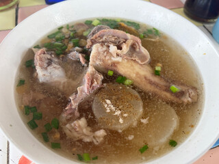 pork with soup in a bowl