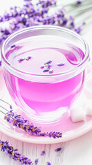 Delicate lavender infused tea in transparent cup with sugar and lavender flowers