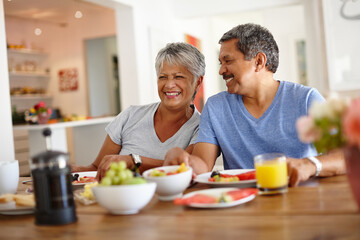 Happy, elderly couple and eating breakfast in home for healthy diet, wellness and support for love....