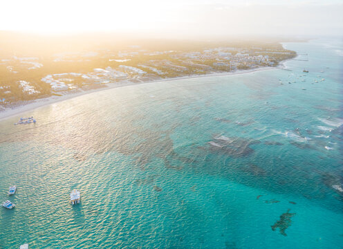 A beautiful blue ocean with a few boats floating on it