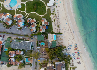A beach with a hotel and a pool