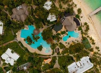 A beautiful beach resort with a pool and palm trees