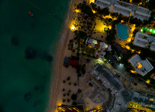 A beach with a hotel in the background