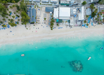 A beach with a hotel and a boat in the water