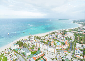 A beach town with a lot of white buildings and a lot of boats in the water