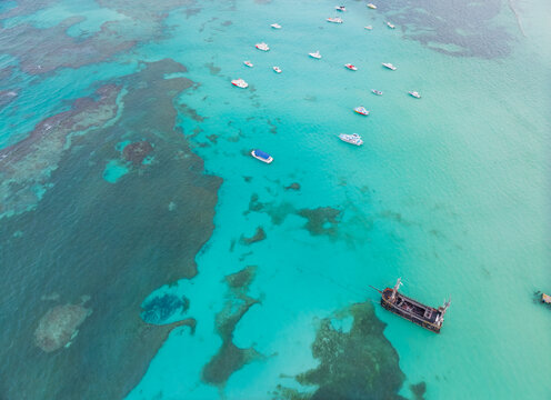 A blue ocean with a boat in the middle of it