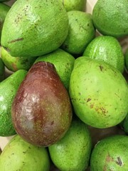 A close-up shot of various avocados, showcasing their unique textures and colors. Perfect for food, healthy eating, or agricultural themes