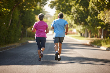 Runner, road and back of senior couple for exercise, training and cardio workout together....