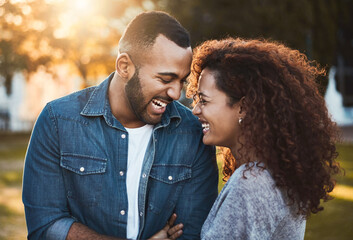 Happy, love and black couple in park laugh together for bonding, relationship and commitment outdoors. Dating, lens flare and man with woman in nature for trust, romance and relaxing on weekend