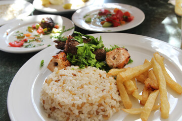 Egyptian rice with french fries, grilled chicken and beef in a Luxor restaurant, Egypt