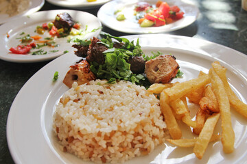 Egyptian rice with french fries, grilled chicken and beef in a Luxor restaurant, Egypt
