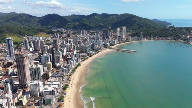 Aerial view of bustling seaside Itapema city and its populated area along with sandy beach, Santa Catarina, Brazil.