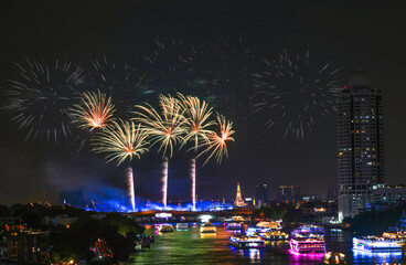 View of Bangkok, Thailand at night, with the Chao Phraya River, beautiful fireworks and boats. Photo taken on 22 Dec 2023.