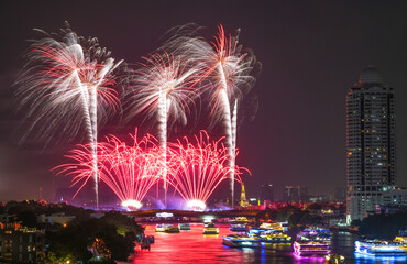 View of Bangkok, Thailand at night, with the Chao Phraya River, beautiful fireworks and boats. Photo taken on 22 Dec 2023.