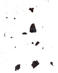 A white background with a lot of black and grey debris scattered around