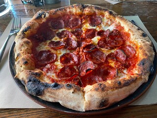 Neapolitan style salami pizza with a thick crust