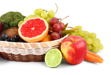 Wicker bowl with different fresh fruits and vegetables on white background