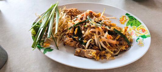 Crispy pork belly Pad thai,favorite Thai cuisine , Thai food Pad thai , Stir fry noodles with crispy pork © sirirat