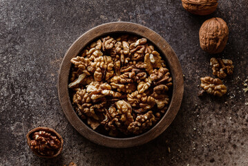 organic raw walnuts in a wooden bowl