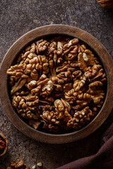 organic raw walnuts in a wooden bowl