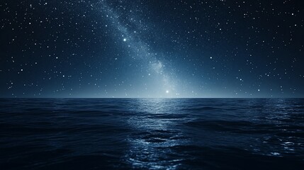 Starry night sky over dark ocean.