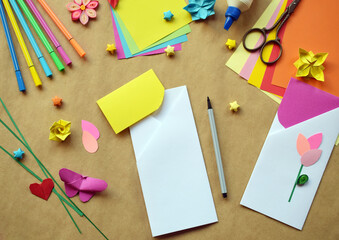 Crafting Handmade Greeting Card Featuring Origami, Quilling. Creative DIY Craft Workspace with Paper Birds, Hearts, Flowers, Decorative Stars and Stationery Tools Arranged 