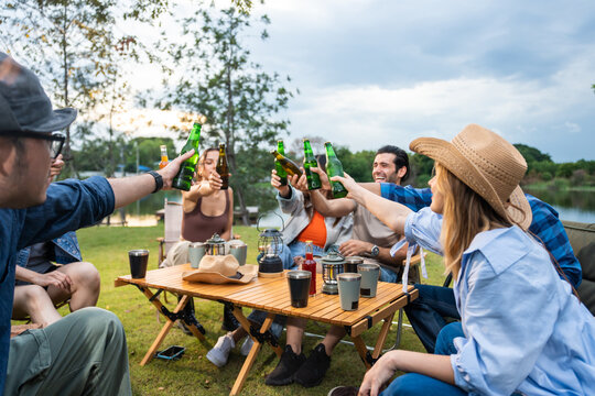 Group of diverse friend having outdoors camping party together in tent. 