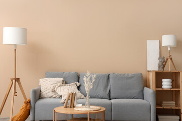 Interior of modern living room with cozy grey sofa and wooden coffee table