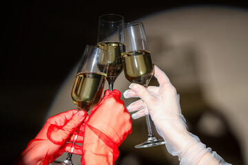 Female hands with glasses of champagne on light background