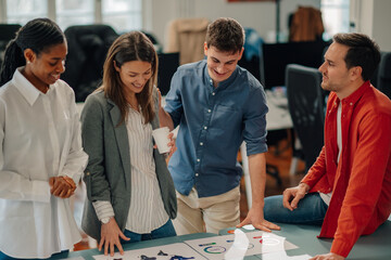 Marketing team analyzing charts and graphs during collaborative meeting